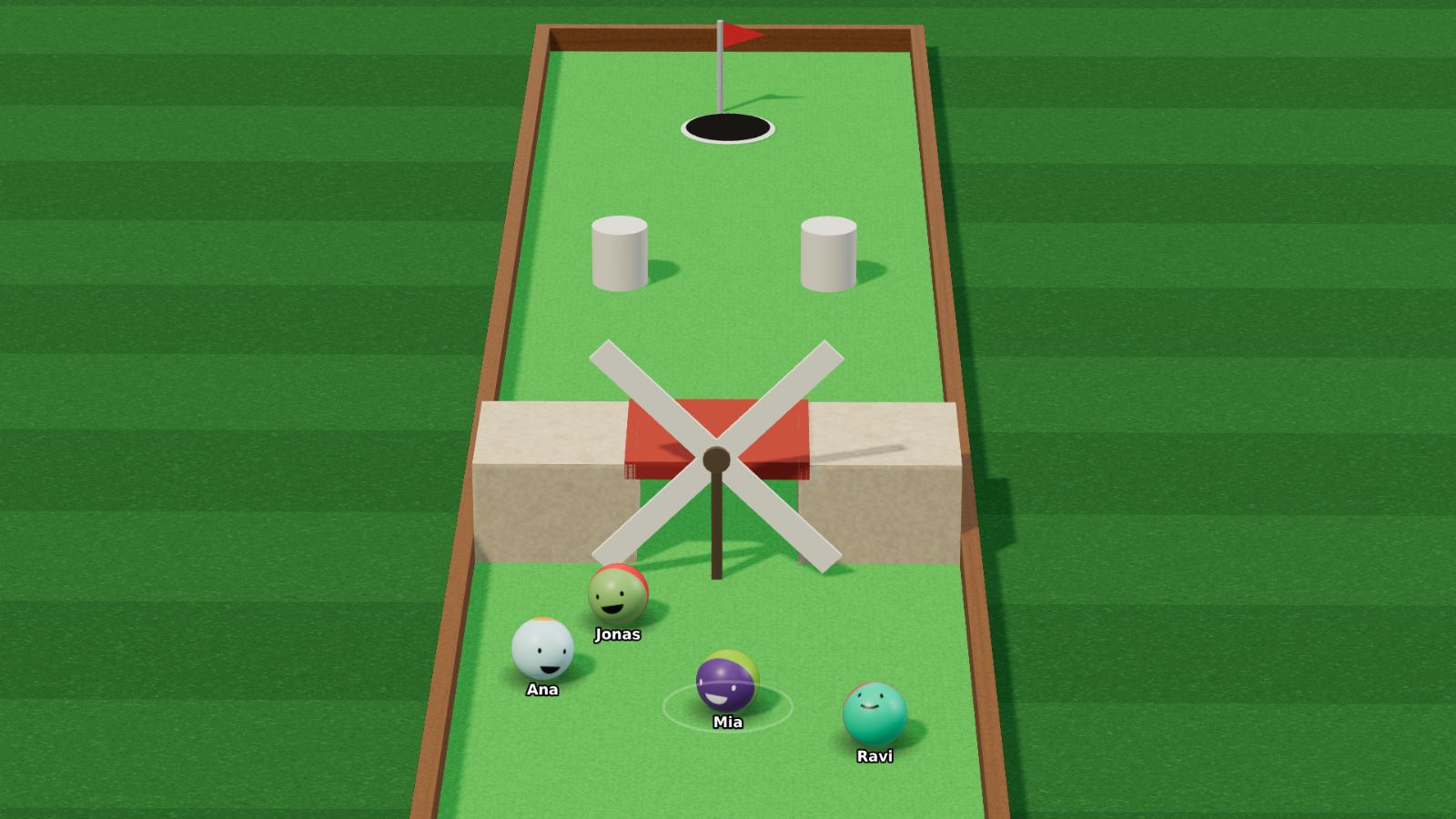 The windmill hole on Kosmi: four players' balls, each wearing its player's face, waiting below the turning blades with the cup and flag beyond